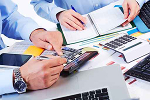 Hands of business people with calculator.